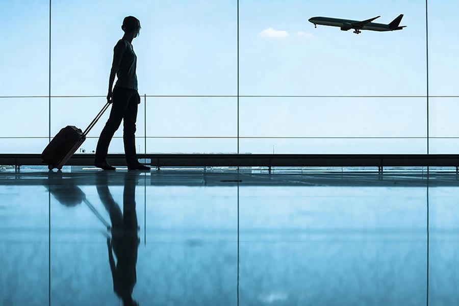 woman walking though airport near windows smithtown ny