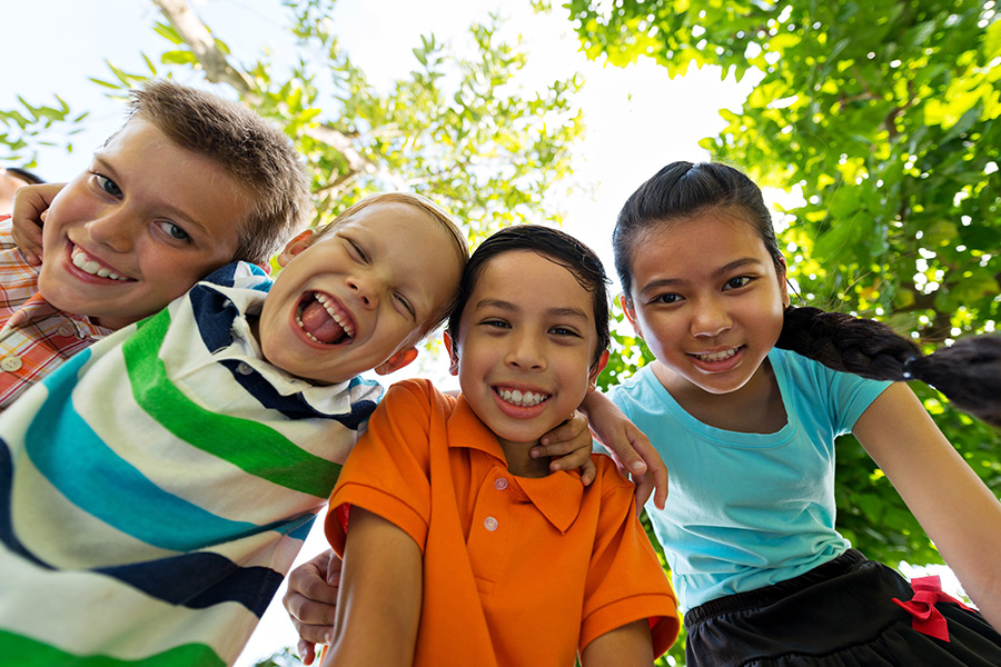 four children laughing and hugging