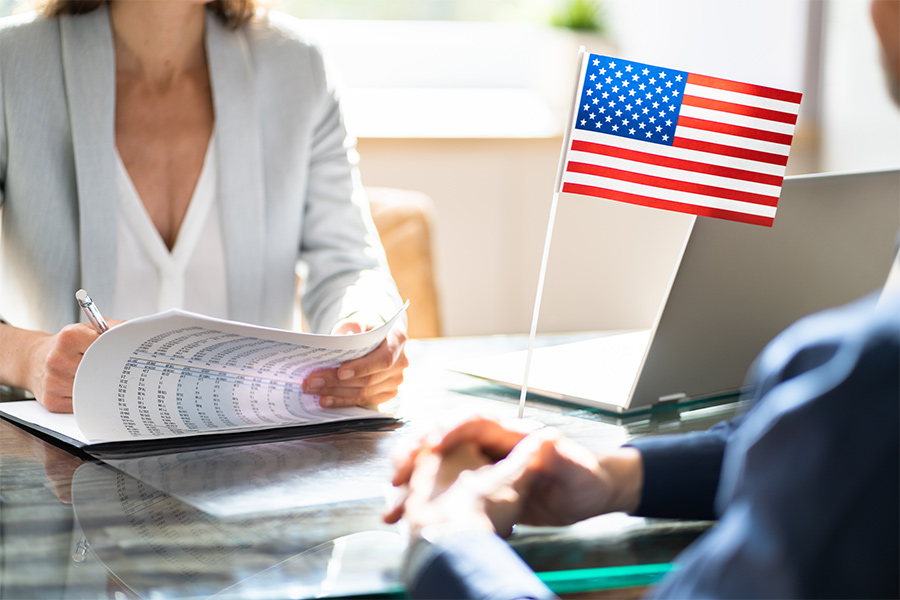 inmigration lawyer close up with usa flag at desk riverhead ny